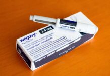 Wegovy injectable pen and its packaging on a wooden surface