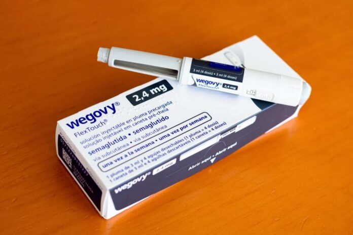 Valencia,,Spain,-,12,September,2025:,Wegovy,Box,,Weight,Loss Wegovy injectable pen and its packaging on a wooden surface