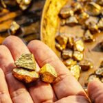 Ancient Gold Rings Hint at Hidden Secret Hand holding raw gold nuggets