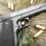 Three Shooters, One Dead — Questions Explode Pistol and bullets on grass with motion blur effect.