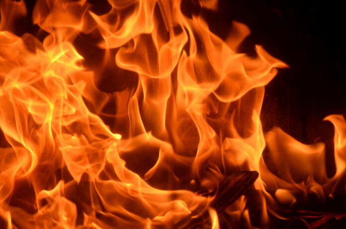 Burning,Fire,With,Red,,Orange,And,Yellow,Flames,Background.,Arson, Close-up of vibrant flames with an orange glow