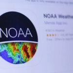 Hottest Month Ever — NOAA Drops Bomb Thermometer displaying high temperature against a bright sun