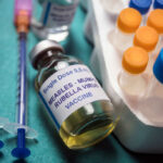 Vaccine Shock: Trump Splits MMR A healthcare professional administering a vaccine to a child's arm