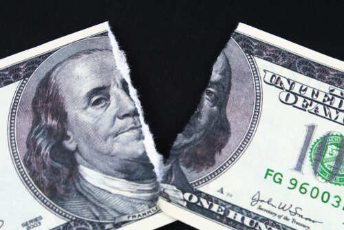 Torn,Ripped,Devalued,One,Hundred,Dollar,Bank,Note,On,A A torn hundred dollar bill featuring Benjamin Franklin