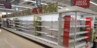 Empty supermarket shelves with great prices signage