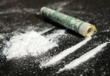 Initiation Twist: Pledges Cut Cocaine Cocaine lines with rolled banknote on surface