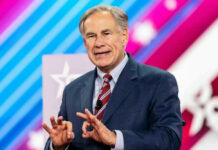 Greg Abbott in suit speaking at an event.