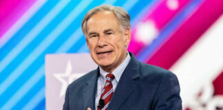 Greg Abbott in suit speaking at an event.