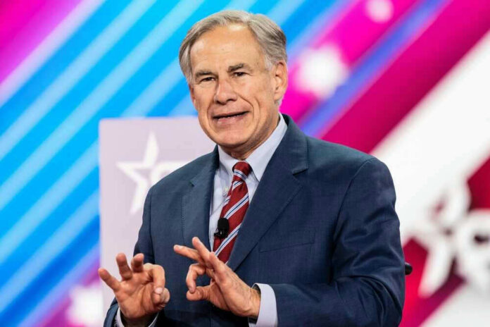 Greg Abbott in suit speaking at an event.