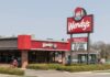 Wendy's fast-food restaurant exterior with large roadside sign