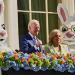 Joe and Jill Biden with Easter Bunny costumes and flower decoration.