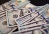 Close-up of scattered hundred dollar bills