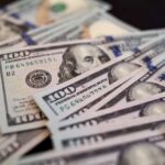Housing Squeeze Forces Boomerang Boom Close-up of scattered hundred dollar bills
