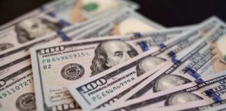 Close-up of scattered hundred dollar bills