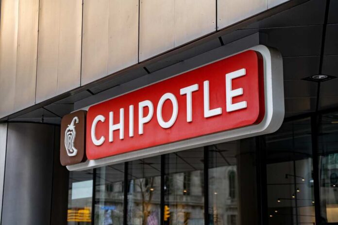 Chipotle,In,Downtown,Toronto.,Chipotle,Mexican,Grill,Often,Known,Simply Chipotle Mexican Grill restaurant exterior with people inside.
