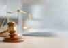Bannon Do-Over Blocked: Judge Wants Receipts A wooden gavel and scales of justice on a desk