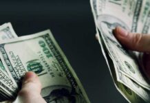 Rewards Offered In Tribal Murder Probes Hands holding and counting stacks of cash