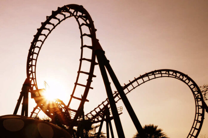 Blurred,Roller,Coaster,Ride,In,Amusement,Park,At,Evening