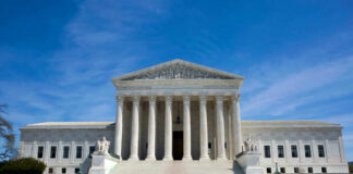 U.S. Supreme Court building under clear blue sky.