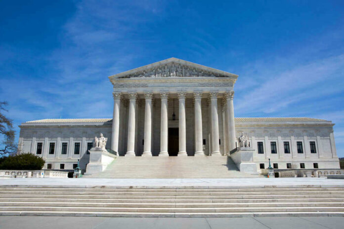 shutterstock_529928383 U.S. Supreme Court building under clear blue sky.