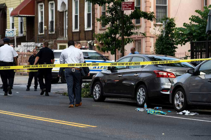1437619232 Police and crime scene tape on city street.