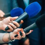 Recall Fiasco Hits Popular Pickup Truck Reporters holding colorful microphones