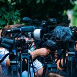 FDA Shake-Up Rocks Suncreens TV news cameras crowding together at an outdoor event