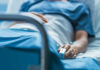 Veteran’s Hospital Nightmare Exposed A patient lying in a hospital bed with a monitoring device in hand