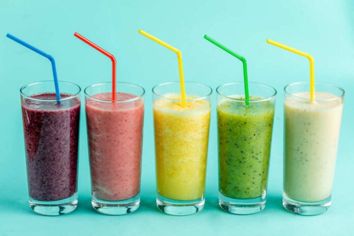 Smoothie,On,Sale.,Small,Business.beverage,For,Good,Mood.event,,Holiday,Concept Four colorful beverage cans on a pink background