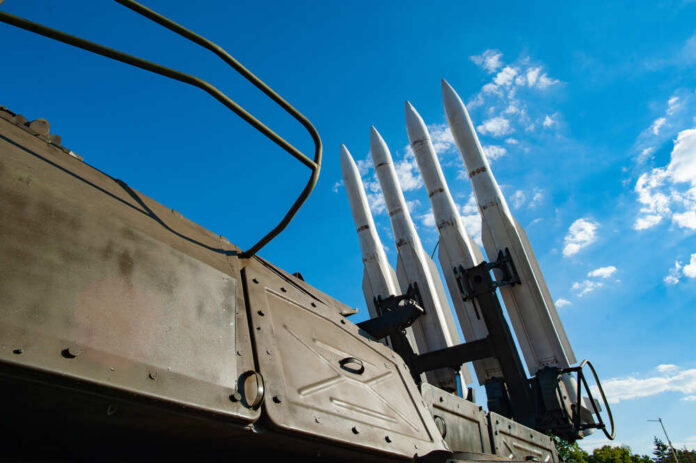 Military,Concept.,Air,Defense,Missiles,On,Position,Against,Blue,Sky Surface-to-air missiles mounted on a military launcher under a blue sky