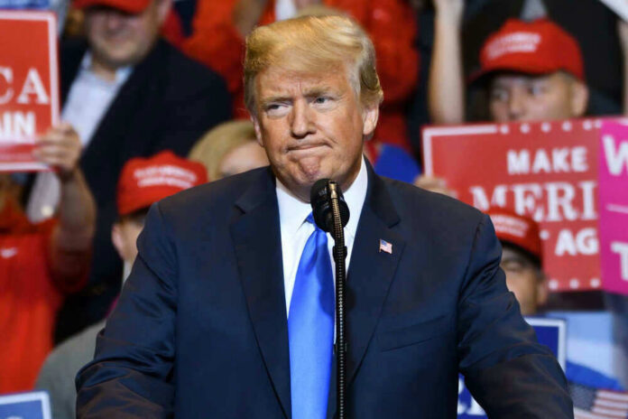 shutterstock_1515374468 President Donald Trump at a rally with supporters.