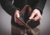 Person holding an open empty wallet