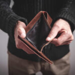 Person holding an open empty wallet