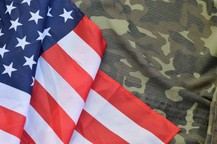 American flag draped over camouflage fabric