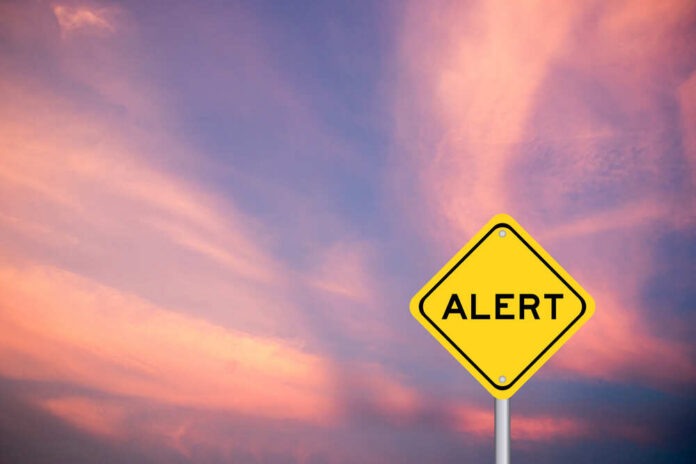 Yellow,Transportation,Sign,With,Word,Alert,On,Violet,Sky,Background Yellow alert sign against a colorful sunset sky