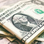 AI Gold Rush Mints THESE Millionaires U.S. dollar bills with George Washington visible.
