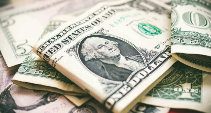 shutterstock_1936555045 U.S. dollar bills with George Washington visible.