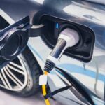 Historic Loss: EV Gamble Backfires – Billions Lost Electric car charging port with plug connected
