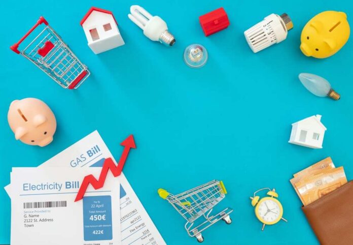 Living,Cost,Increase,,Economic,Crisis,Flat,Lay.,Shopping,Cart,Utilities Household bills, piggy banks, and energy items on blue background