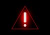 Red warning triangle with exclamation mark on black background