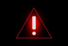 ALERT: Surveillance Of Americans Surges In DC Red warning triangle with exclamation mark on black background