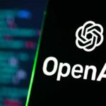 OpenAI logo on a smartphone screen with code blurred in the background