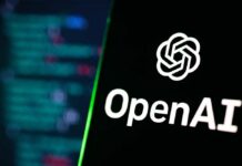 AI Firings Hit New Parents? OpenAI logo on a smartphone screen with code blurred in the background