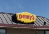 Dennys sign illuminated against a twilight sky