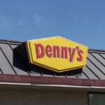 Dennys sign illuminated against a twilight sky