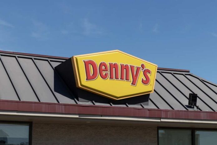 Indianapolis,-,Circa,April,2023:,Denny's,Fast,Casual,Restaurant,And Dennys sign illuminated against a twilight sky