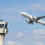 Mystery Cut Cripples Skies Over U.S. An airplane taking off near an airport control tower