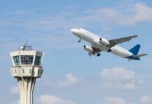 Mystery Cut Cripples Skies Over U.S. An airplane taking off near an airport control tower