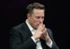 NOW: Musk Money Floods THESE Battleground States Elon Musk in a suit deep in thought, black background.