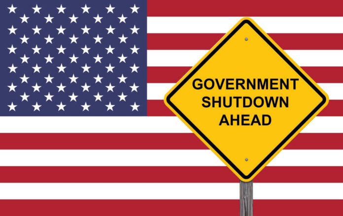 shutterstock_2411673609 American flag government shutdown warning sign